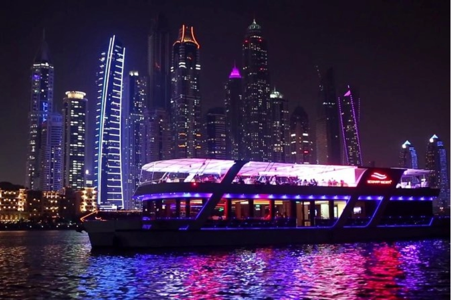 Glass dhow with Dubai skyline & Atlantis views, plus live entertainment.